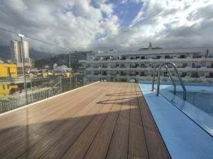 a swimming pool on the roof of a building at Hotel Tropical in Puerto de la Cruz