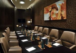 a conference room with tables and chairs and a painting at EMAAR Residences Fashion Avenue - former Address Dubai Mall Residences by Qstay in Dubai