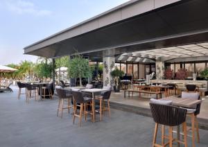 an outdoor seating area with tables and chairs at EMAAR Residences Fashion Avenue - former Address Dubai Mall Residences by Qstay in Dubai