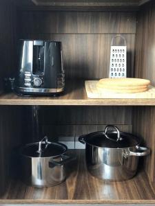 two pots and pans on a kitchen counter with a microwave at Studio Flat in London