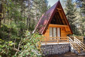 a cabin in the woods with a thatched roof at Peace of mind in Žabljak