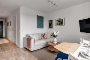 a living room with a couch and a table at Cosy Urban Home in Stockholm in Stockholm