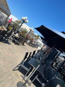 a group of tables and chairs with an umbrella at Smiths Hotel in Weston-super-Mare