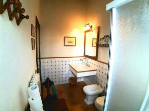 a bathroom with a sink and a toilet at Villa Saturnia in Saturnia +15 photos