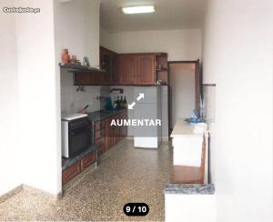 a kitchen with a refrigerator and a stove at Santa Cruz in Silveira +1 photo
