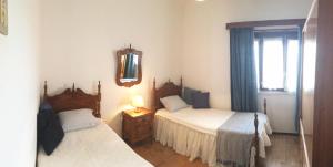a bedroom with two beds and a window at Santa Cruz in Silveira