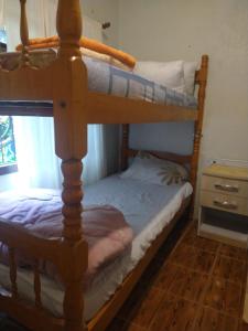 2 letti a castello in una camera con tavolo di Hostel REIBIER a Blumenau