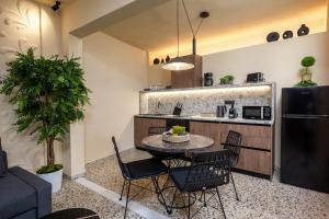 a kitchen and dining room with a table and chairs at Townhall Apartment in Symi