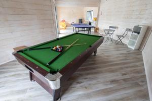 a pool table in a room with a pool at Nadmorska Perełka in Rusinowo