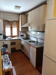 a kitchen with a sink and a dishwasher at El rincon de los enebros in Ruidera