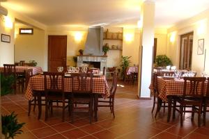 a restaurant with tables and chairs with wine glasses at Agriturismo La Mancosa in Pollica