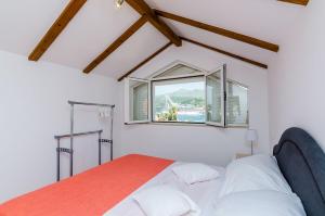 a bedroom with a bed and a window at Apartment Marina View in Dubrovnik
