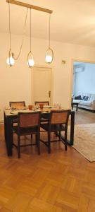 a dining room with a table and two chairs at Luxury Apartment 3 Rooms in Bucharest