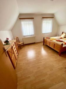 a large room with a bed and a desk at Steirer Haus in Gamlitz