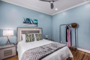 a bedroom with a bed and a ceiling fan at Luxury Designer Villa by the Beach Bright Beautiful Brand New in Galveston
