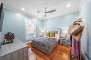 a bedroom with a bed and a ceiling fan at Luxury Designer Villa by the Beach Bright Beautiful Brand New in Galveston