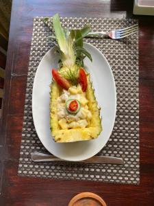 a white plate of food on a table at Crystal Bay Villa in Nusa Penida