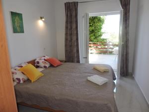 a bedroom with a bed with colorful pillows on it at Pansion Berat in Vodnjan +52 photos
