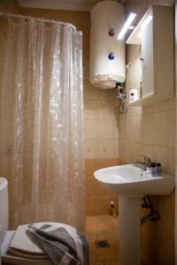 a bathroom with a sink and a shower curtain at Cozy cave kavala in Kavala