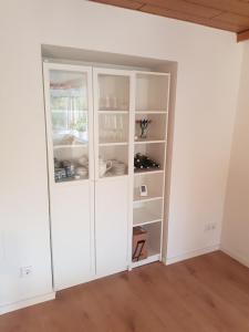 a room with a white cabinet with shelves at Alter Bahnhof Blickweiler in Blieskastel