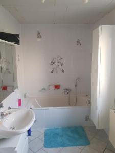 a bathroom with a tub and a sink and a bath tub at Alter Bahnhof Blickweiler in Blieskastel +12 photos