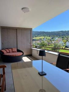 a living room with a table and a couch at Sonnige Wohnung mit schöner Aussicht in Wolfurt in Wolfurt