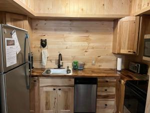 a kitchen with a sink and a refrigerator at Gatlinburg Mountain Condo in Gatlinburg