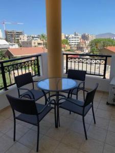 a patio with a table and chairs on a balcony at Klimentos Flat 59 in Nicosia