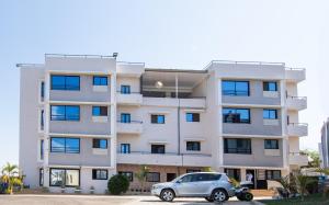 a car parked in front of a building at Milestone City - Appartements à louer in Antananarivo