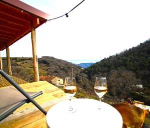 two glasses of wine sitting on a table at La Ferme de Samson in Saint-Péray