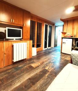 a living room with wooden floors and a flat screen tv at La Ferme de Samson in Saint-Péray +13 photos