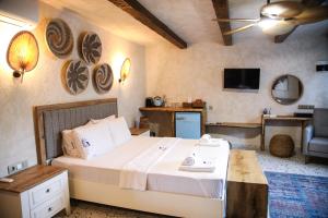 a bedroom with a large bed and a living room at MAVİ AT HOTEL Blue Horse in Gümüşdere