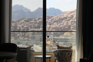 a room with a view of a mountain through a window at H Luxury Hotel in Wadi Musa