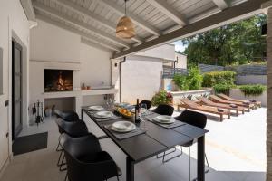 a dining room with a table and chairs at Modern villa Molindrio with pool in Porec in Poreč