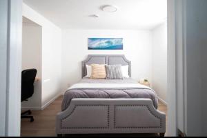 um quarto com uma cama e uma cadeira num quarto em 2BR 1BR cozy basement suite em Leduc