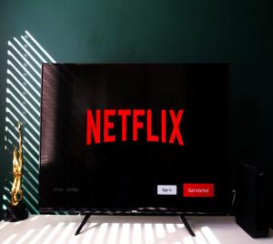 a television screen with the netflix sign on it at #1 Limes by DerBnB, Modern 1 Bedroom Apartment, Free Parking, WI-FI & Netflix Near Royal Derby Hospital in Derby
