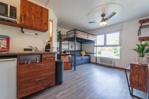 a kitchen and living room with a loft bed at Sympathique appartement au pied du Futuroscope in Jaunay-Marigny