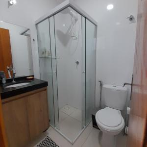 a bathroom with a shower and a toilet and a sink at Casa Nova Tatuapé in Sao Paulo