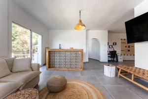 a living room with a couch and a tv at Casa Rocas in Mijas