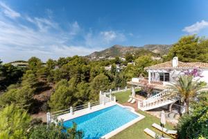 an aerial view of a house with a swimming pool at Casa Rocas in Mijas