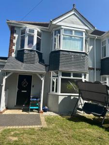 a house with a bench in front of it at Chi Lodge & Accommodation in Rainham