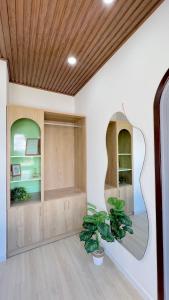 a room with a mirror and a potted plant at HaHe Homestay in Da Lat +10 photos