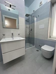 a bathroom with a toilet and a sink and a shower at Blue Sea Salerno in Salerno +49 photos