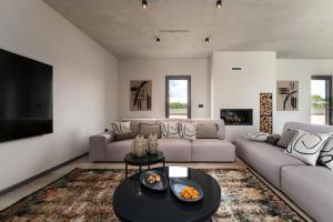 a living room with a couch and a table at Luxury Villa Lipa Tree with pool in Novigrad in Novigrad Istria