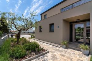 a house with a patio and a tree in front of it at Luxury Villa Lipa Tree with pool in Novigrad in Novigrad Istria
