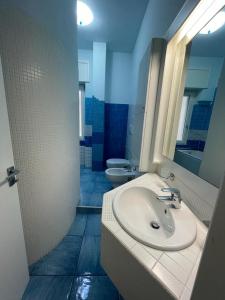 a bathroom with a sink and a mirror and a toilet at Blue Sea Salerno in Salerno +19 photos