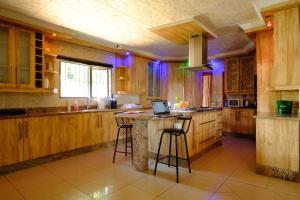 a kitchen with a island with a laptop on it at Alimop Bed and Breakfast in Midrand
