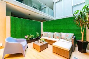 a living room with a green wall and a couch at Trendy La Roma Condo with Parking & Patio in Mexico City