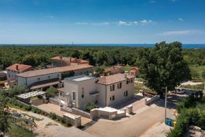 an aerial view of a house in a village at Modern villa Blagdan with pool in Porec in Nova Vas