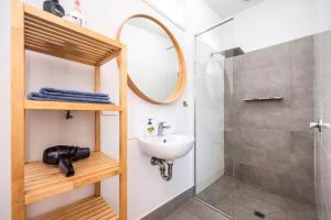 a bathroom with a sink and a shower at Captain's Heritage Cottage - central Fremantle 2 bedroom historic cottage in Fremantle